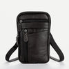 A black vintage cowhide leather crossbody bag with a zipper and adjustable strap.