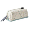 A cream-colored pencil case with a vertical quilted pattern of multi-colored dots, featuring a grey tie closure.