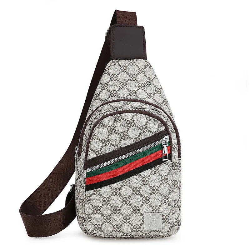 A beige and black patterned printed crossbody sling bag with a green, red, and black stripe detail.