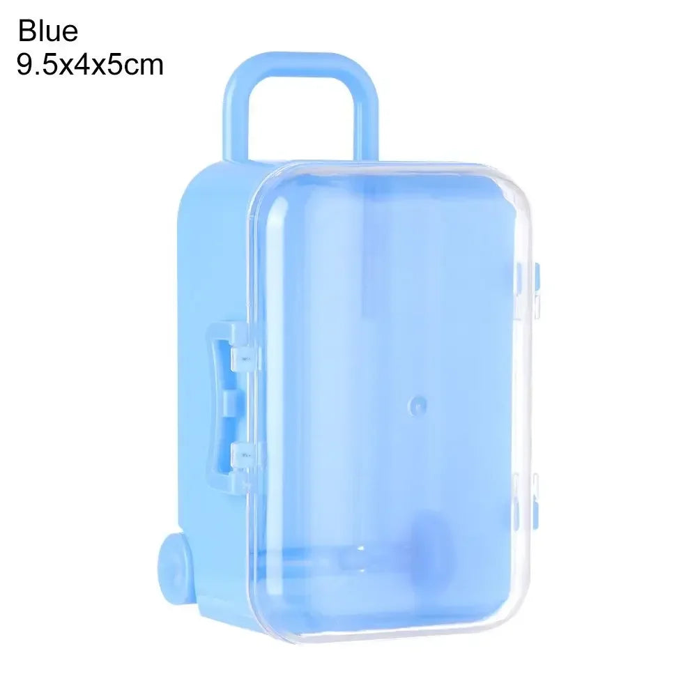 A light blue miniature doll suitcase with a handle and clear plastic body.