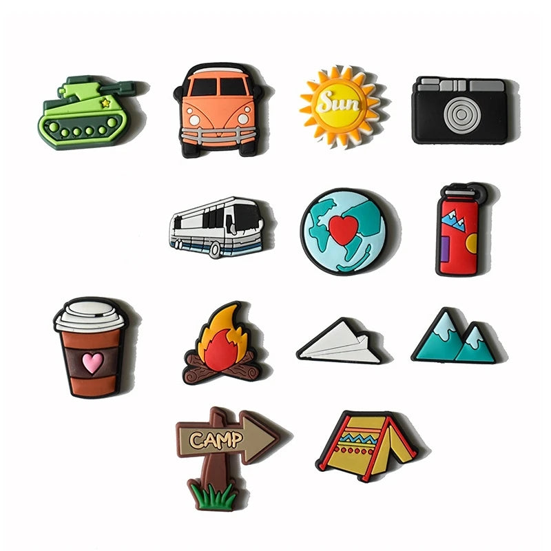 A collection of decorative shoe charms and pins including a military vehicle, a sun, a camera, a bus, a globe, a coffee cup, 