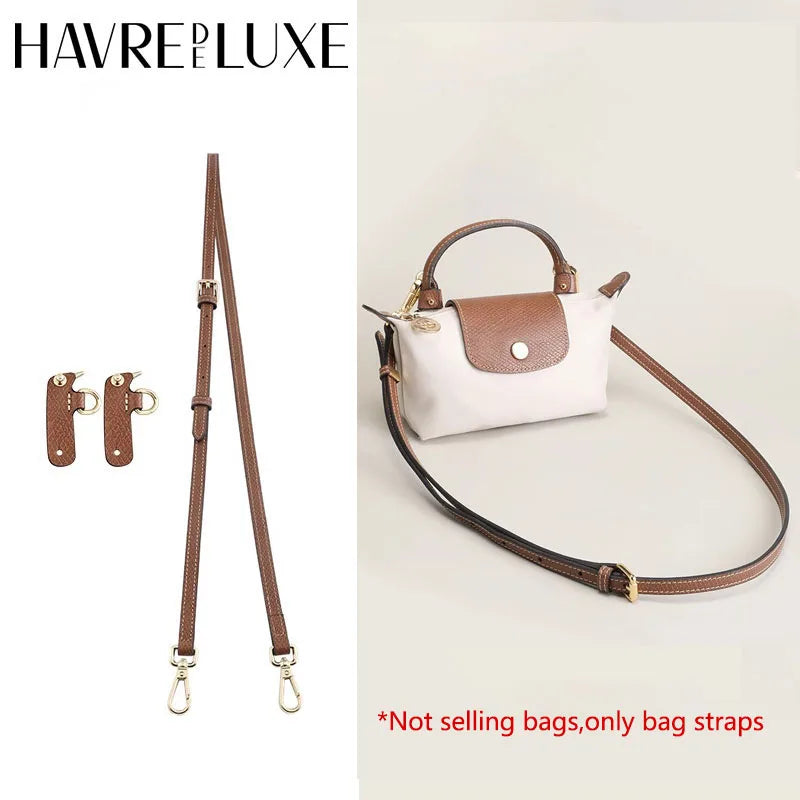 A brown leather crossbody bag strap with a white and brown accent, shown against a light background.