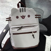 A light gray Pusheen cat canvas backpack with brown accents resting on a dark chair.