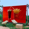 A red banner featuring a McDonald's logo and a serving of french fries displayed in a glass container outdoors.