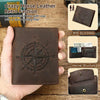 A brown leather wallet featuring an engraved compass design, shown being held by a hand.