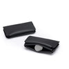 Black magnetic foldable ID card holder and coin purse lying flat on a white background.