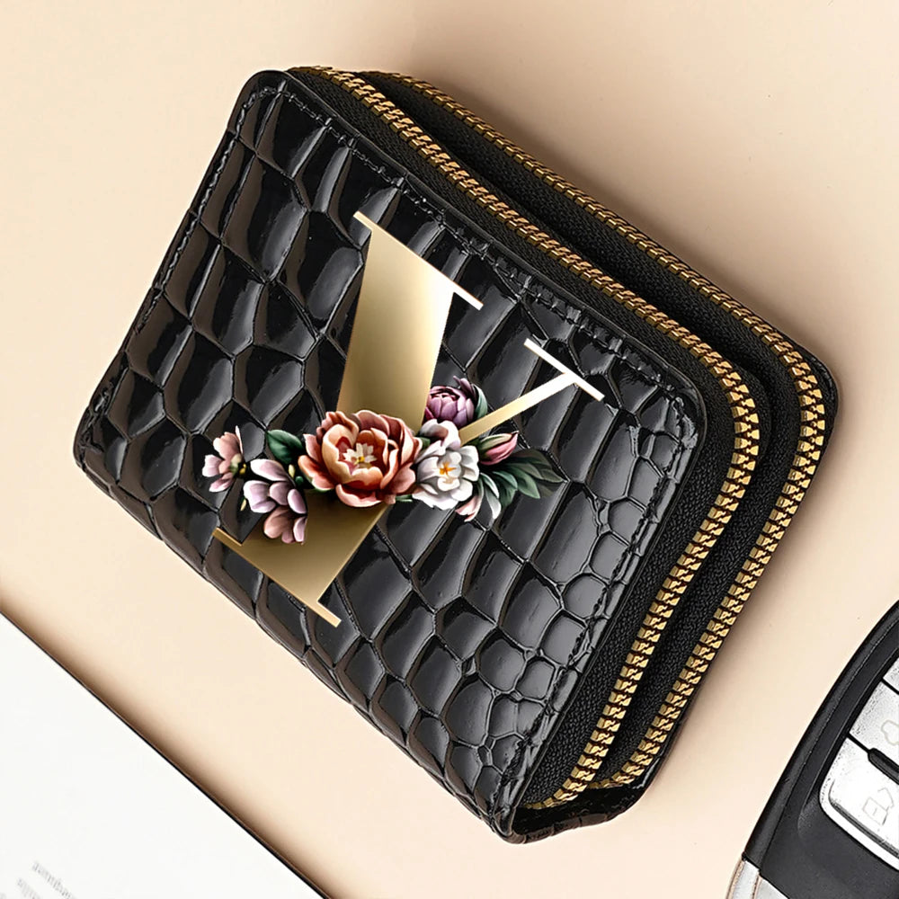 A black PU leather double-zip clutch wallet with a gold accent and floral cartoon print.