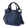 Navy canvas crossbody bag with adjustable strap and multiple pockets