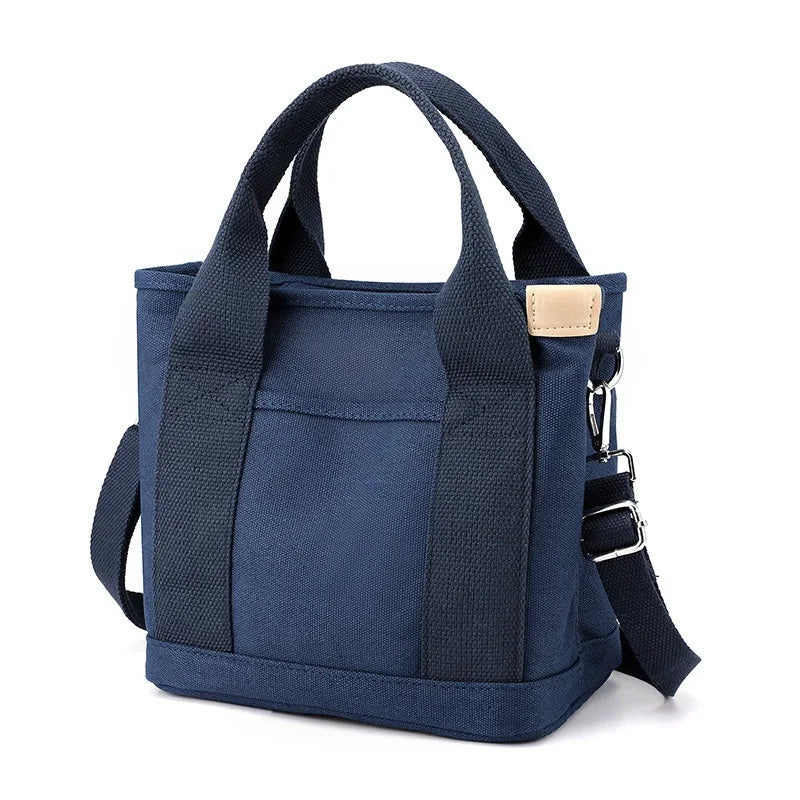 Navy canvas crossbody bag with adjustable strap and multiple pockets