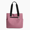 A pink nylon shoulder tote bag with black straps and a zippered pocket.