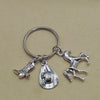 Silver keychain set featuring a cowboy boot, hat, and horseshoe charms.