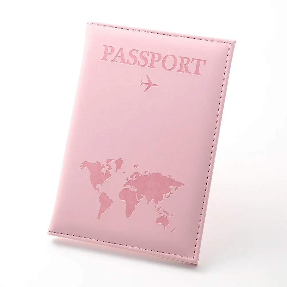 A pink passport wallet made of PU leather featuring a world map design and an airplane icon.
