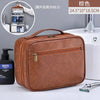 A brown PU leather cosmetic organizer bag is shown next to a sink and grooming tools.
