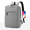 A gray versatile USB-rechargeable laptop backpack with black straps shown from the front.