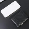 A slim black wallet with a textured cover is shown next to a blank white card holder.
