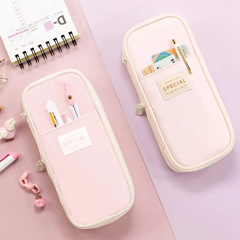 A pink pencil case with a zipper, featuring a special tag and various stationery items, displayed on a light purple surface.