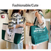 A woman is holding a green Snoopy canvas tote bag in a light-colored outfit.