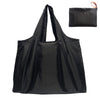 Black foldable water-resistant shopping tote bag with shoulder straps shown in a flat lay view.