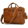 A brown vintage genuine leather briefcase with leather straps and a flap closure.