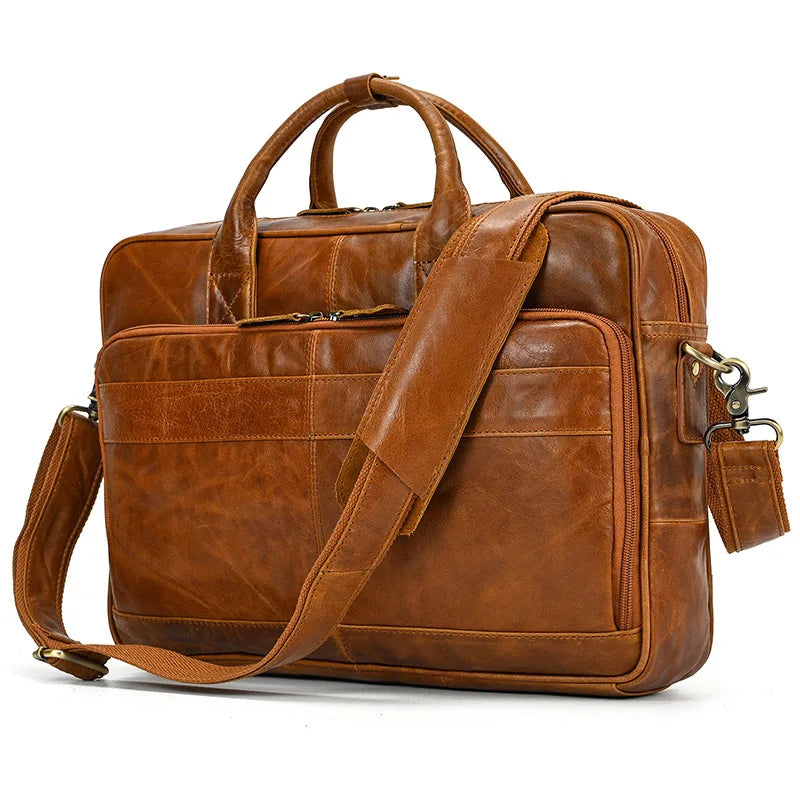 A brown vintage genuine leather briefcase with leather straps and a flap closure.
