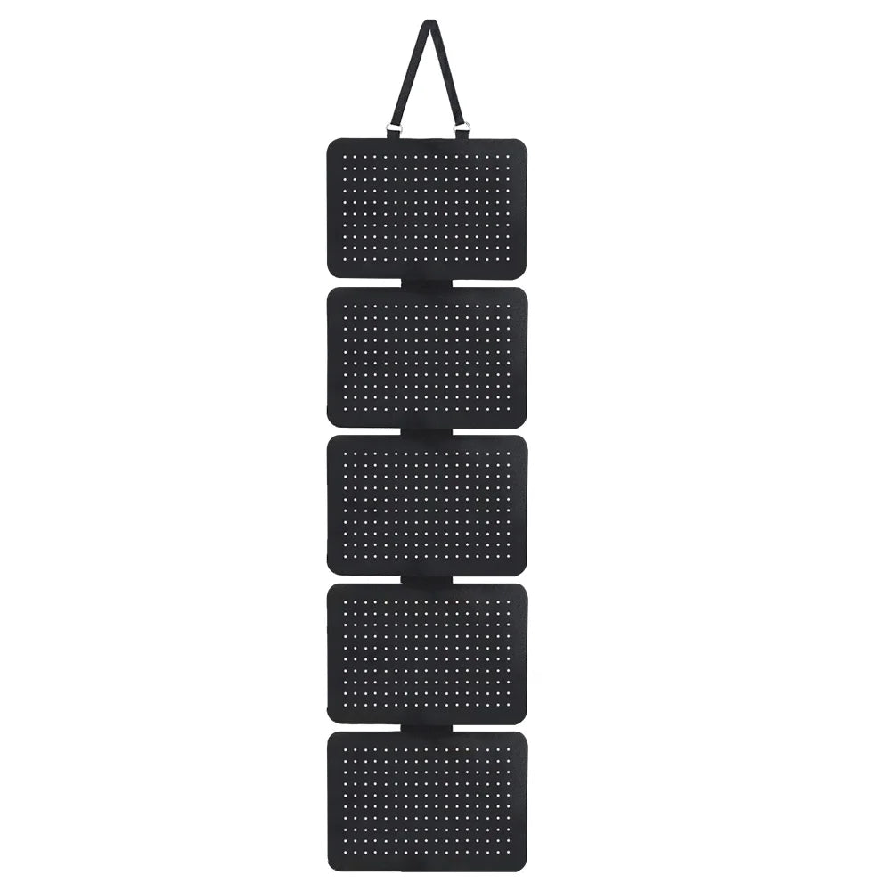 Black wall-mounted jewelry organizer with five stacked grid compartments.