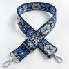 A navy blue and white floral patterned fabric strap for a crossbody bag, featuring silver hardware.