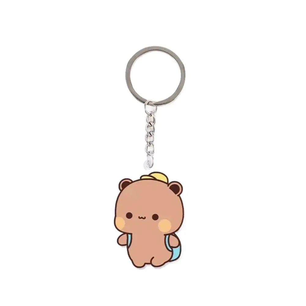A round silver keychain charm with a cute brown bear character attached.