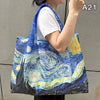 A woman holds a blue and yellow watercolor print shopping tote bag against a gray background.