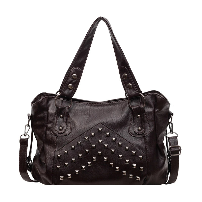 A black leather tote bag featuring decorative silver rivets and stitching.