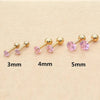 Set of gold-toned stainless steel ear stud earrings in various sizes 3mm, 4mm, and 5mm with pink stones