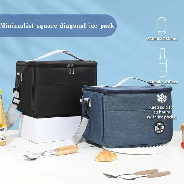 A black and blue insulated thermal lunch bag is shown with ice packs, cutlery, and bread on a white surface.