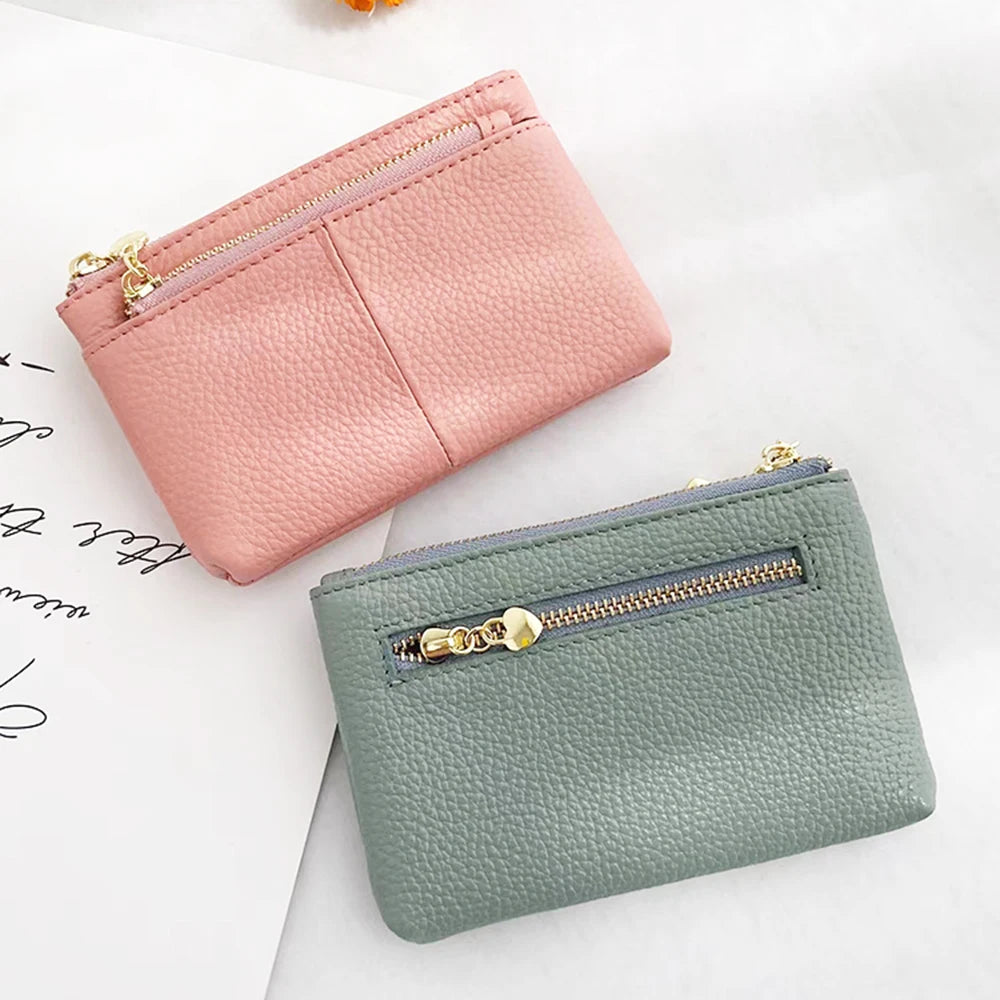 A pink leather zipper card holder and a green leather zipper card holder are shown on a white background.