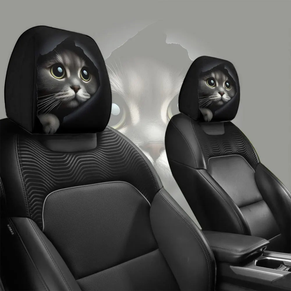 A pair of black car headrest covers featuring a cute cat face design.