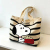 A beige canvas shoulder bag featuring a Snoopy cartoon design with food inside.