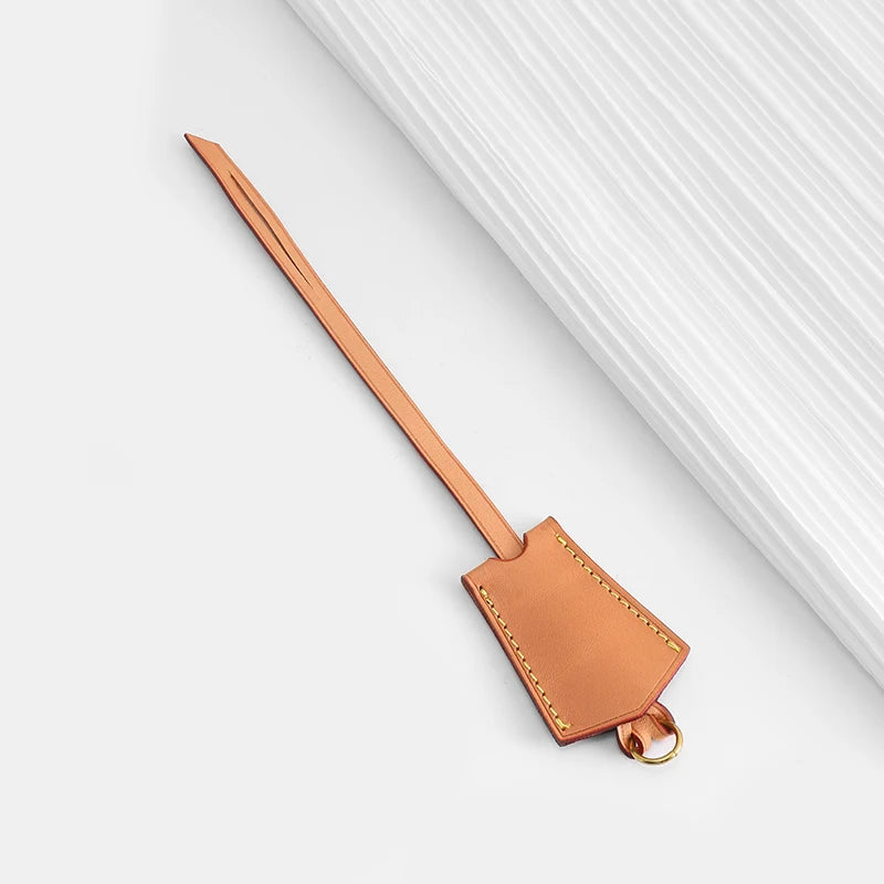 A genuine Vachetta leather bag strap in a light brown color is shown against a white background.