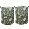 Un ensemble de paniers à linge en tissu avec un motif de feuilles tropicales vertes et roses.