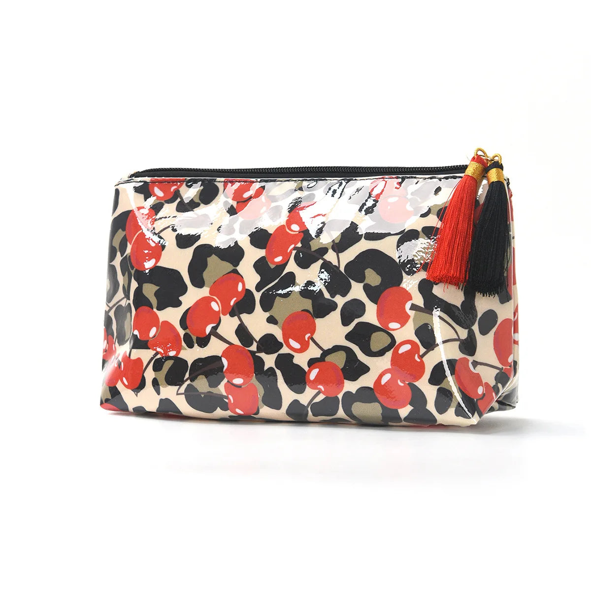 A cosmetic travel pouch featuring a leopard print and red fruit pattern with black lining and orange fringe.