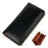 A black genuine leather zipper wallet shown from above with a gold-colored stitching detail.
