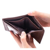 A hand holds an open brown genuine leather men's business wallet with a zipper.