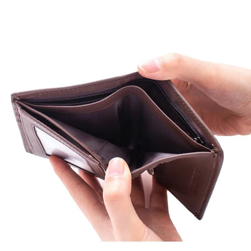 A hand holds an open brown genuine leather men's business wallet with a zipper.