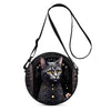 A black cartoon cat round crossbody bag with gold accents and a black strap.