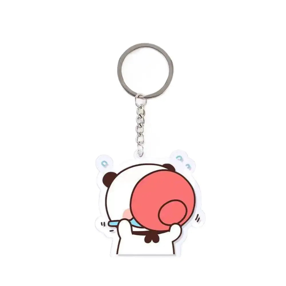 A cute cartoon panda face charm with a pink circle on its cheek, attached to a silver keyring.