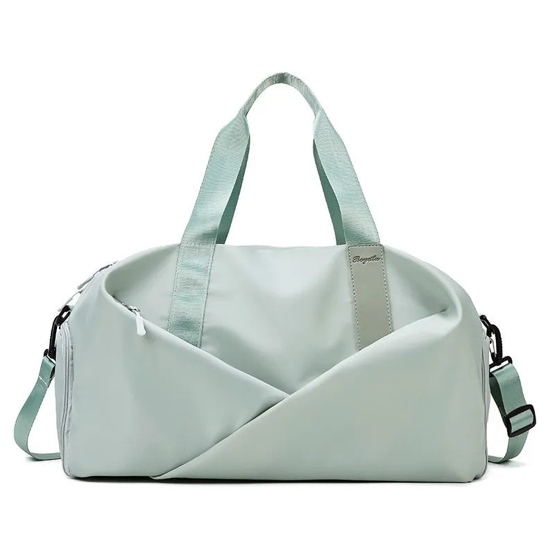 A light mint green nylon duffel bag with padded straps and a diagonal design.