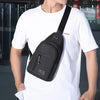 A man wearing a white t-shirt carrying a black versatile crossbody sling chest bag.