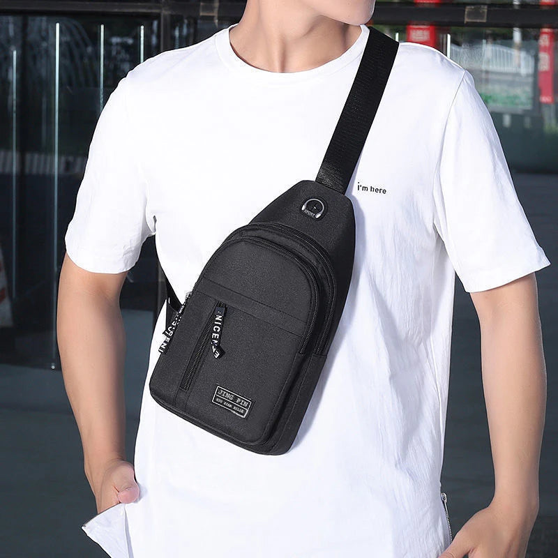 A man wearing a white t-shirt carrying a black versatile crossbody sling chest bag.