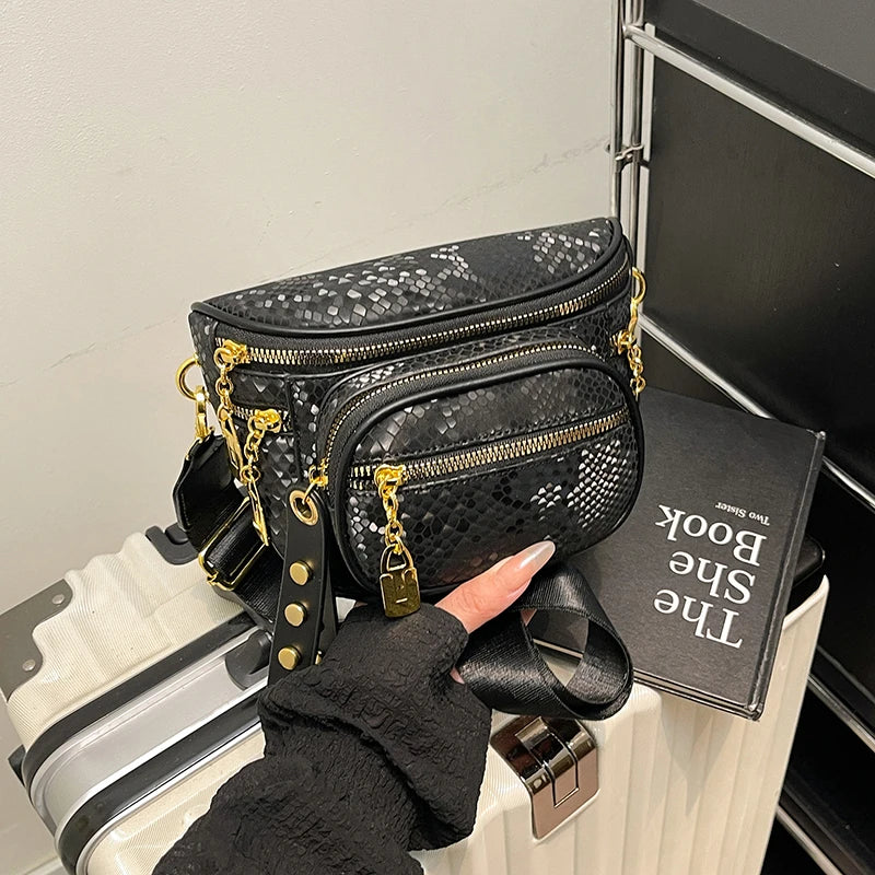 A black patterned women's rivet waist bag is displayed next to a black book on a white surface.