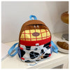A brown and yellow patterned backpack with blue straps resting on a white surface.