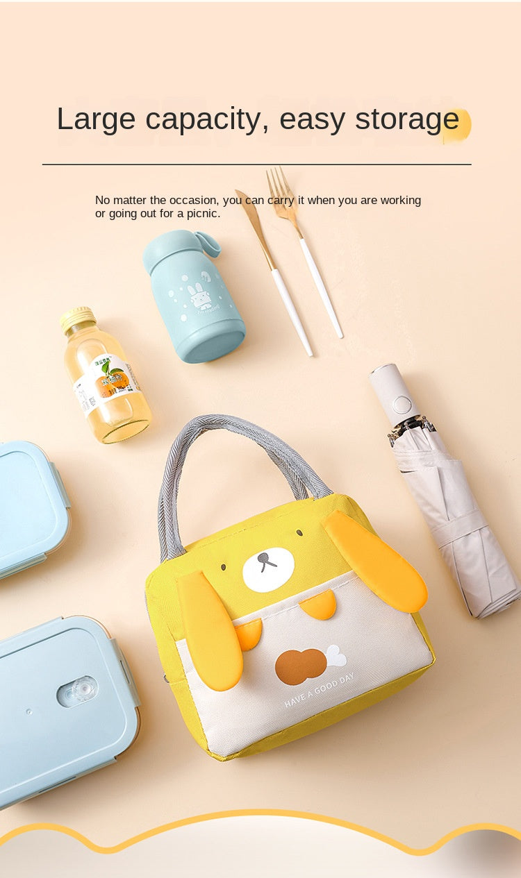 A yellow insulated thermal picnic lunch bag with a bear face is shown next to various picnic items and a water bottle.