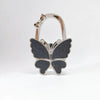 Silver foldable butterfly shaped handbag hook with sparkling details