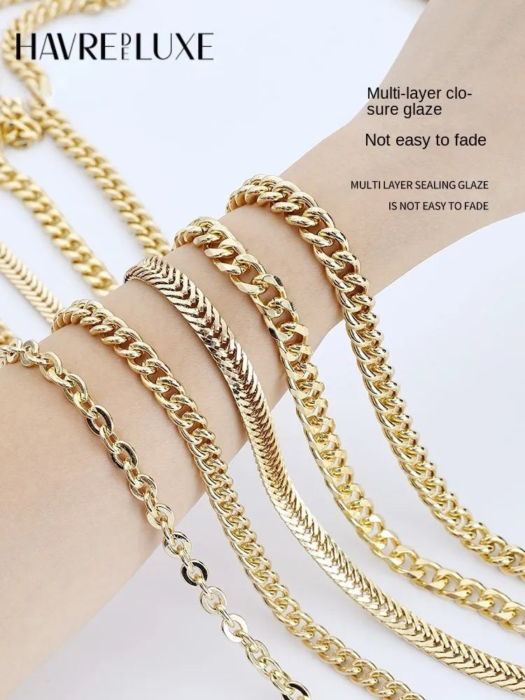 Multiple strands of multi-layer gold chain material displayed on a hand for jewelry or bag straps